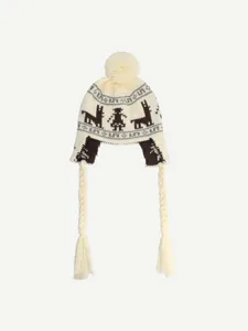 Close-up detail of the Fair Isle jacquard knitted winter trapper hat with braids and pom-pom.