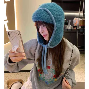 Cozy fuzzy winter trapper hat for women, thick warm earflap knit beanie for cold weather.