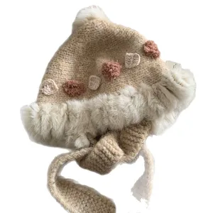Handmade knit winter trapper hat with fluffy faux fur trim and cute crochet floral decor.
