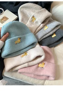 Detailed view of cute puppy embroidery knit beanie showing cozy winter hat texture.