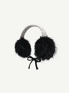 Close-up detail of fluffy black winter earmuffs with tweed headband and cute bow accent.