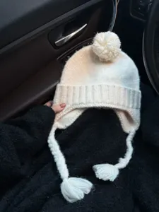 White knitted trapper hat with pom pom and earflaps, cute winter warm braided tassel beanie.
