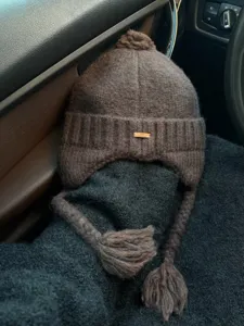 Brown knitted pom-pom ear-flap hat detail, warm winter thermal trapper beanie for women.