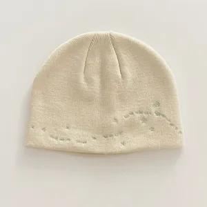 Close-up detail of the Korean style knit beanie hat with cute star embroidery and cozy texture.