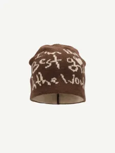 Detailed view of the brown knitted beanie with woven text, cozy winter streetwear style.