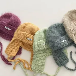 Mohair knitted earflap hat details showing multiple color options and soft fuzzy texture.