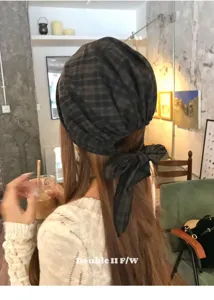 Detail view of the retro plaid tie-up turban hat showcasing its back bow and soft fabric.