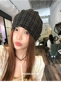 Detailed view of the vintage plaid slouchy beanie hat, showcasing soft fabric and texture.