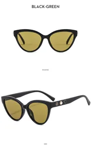 Detail view of black cat-eye sunglasses featuring chic camellia and pearl temple accents.