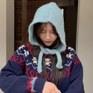 Women winter warm knitted balaclava hooded hat and cute pattern sweater fashion stylish outfit.