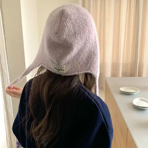 Women winter warm knitted ear-flap beanie hat, stylish cozy solid color cap for cold weather.