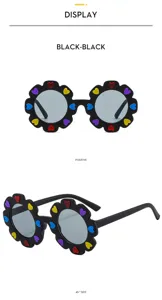 Detailed view of cute kids flower sunglasses with colorful heart embellishments and black frame.