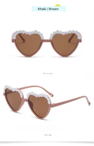 Children heart sunglasses detail view showing cute white lace trim and brown lenses.