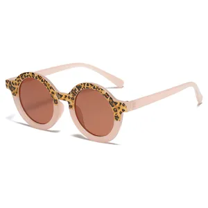 Cute kids round sunglasses with leopard print frame and pink jelly temples, UV protection main image.
