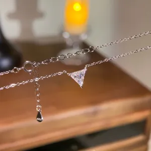 Silver triangular moissanite pendant necklace with adjustable chain for women elegant daily wear.