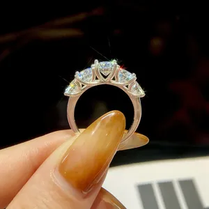 Exquisite five-stone moissanite ring detail with sparkling stones and polished silver band.