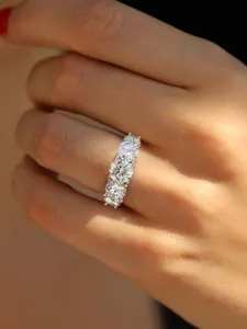 Close-up detail of a stunning 5-stone moissanite ring set in sparkling silver for women.