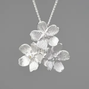 Nahaufnahme einer exquisiten S925 Silber Dreifach-Blumenanhänger Halskette mit Struktur.