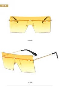 Occhiali da sole oversize con parte superiore piatta e lenti sfumate gialle, stile urbano.