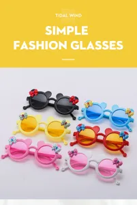 Cute kids sunglasses with bear ears and bows, colorful stylish sun glasses for children detail view.