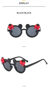 Cute black children sunglasses with mouse ears and red bow for sunny outdoor beach days.