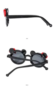 Kids black round sunglasses detail view showing folding temple and cute cartoon ear and red bow.