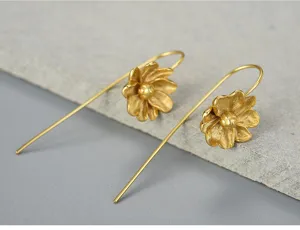 Detailed shot of long jasmine flower hook earrings in matte gold finish, elegant and fresh.