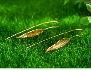 Detail shot of exquisite leaf shaped long drop earrings with sparkling micro set cubic zirconia.