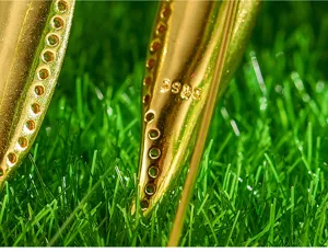 Detailed macro view of sterling silver gold-plated bamboo leaf earrings with stamp.
