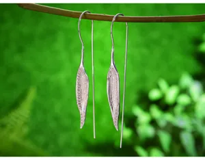 Long S925 sterling silver leaf drop earrings nature inspired elegant jewelry detail shot.