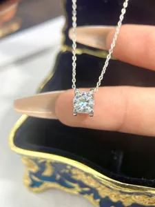 Stunning 2-carat solitaire moissanite necklace with classic four-prong crown pendant setting.