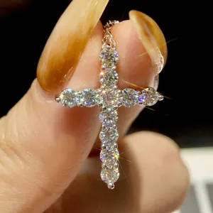 Exquisite moissanite cross pendant necklace detail, sparkling diamond-like stones set in silver chain.
