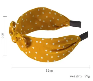 Cerchietto in tessuto a pois gialli e bianchi con fiocco, larghezza 12cm, peso 29g.