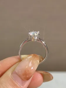 Exquisites Detail des Sechskragen-Solitärrings, funkelnder Stein, eleganter silberner Ring.