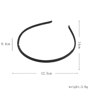 Detail close-up view of black plastic hair hoop with teeth, slim matte finish for daily hair styling.