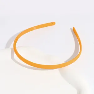 Detailed shot of orange frosted plastic headband with anti-slip teeth, simple design