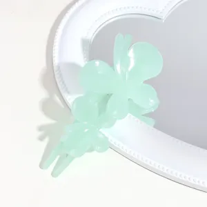 Green translucent butterfly hair claw detail, frosted texture chic accessory for styling.