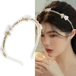 Detailed view of the exquisite gold-tone metal rhinestone flower hairband worn elegantly.