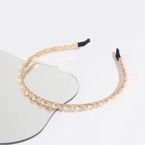 Detailed view of the elegant gold pearl and pink crystal headband, delicate rhinestone hair accessory.