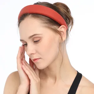 Closeup detail of a wide sponge fabric headband worn by a model, soft plush texture style.