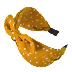 Cerchietto giallo a pois con nodo accessorio dettaglio in tessuto per un look alla moda.