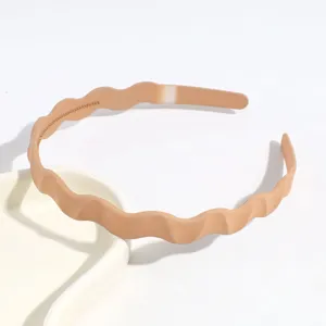 Gros plan détaillé du serre-tête ondulé minimaliste en plastique de couleur unie, accessoire chic.