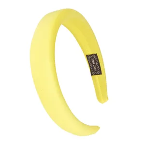 Detail shot of the yellow velvet sponge headband, showing the fine texture and handmade label.