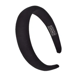 Detail shot of black wide padded velvet headband featuring hand-made inner label design.