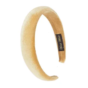 Detailed view of a trendy champagne velvet padded headband with handmade label for women.