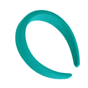 Close-up detail of the teal wide fabric headband, showing soft texture and neat stitching.