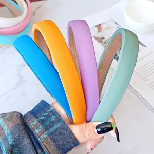Close-up detail of colorful sponge headbands in blue, orange, purple, and green shades.
