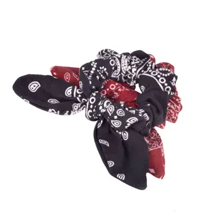 Detail view of black and red paisley print hair scrunchie with cute rabbit ear knot design.