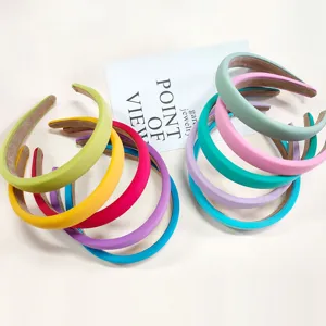 Close-up detail of assorted colorful padded headbands, showing vibrant fabric textures and design.
