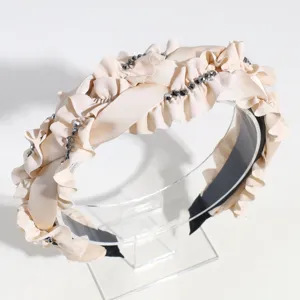 Detailed view of wide beige satin ruffle rhinestone headband, elegant hair accessory for women.
